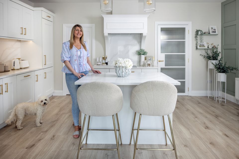 Interior designer Sarah O’Neill in the kitchen of her home in Firhouse with her beloved Cavapoo Coco. Photo: Tony Gavin